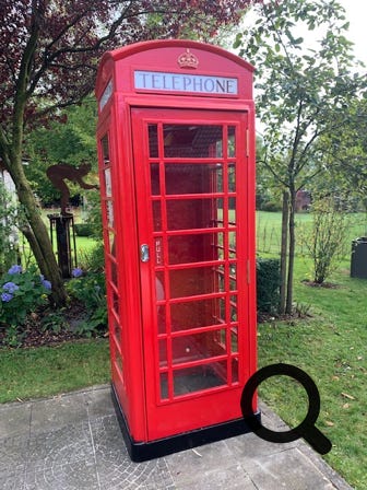 Red British Telephone Box as a tool shed